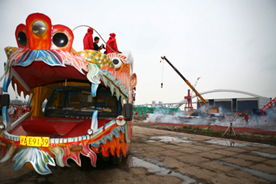 Festooned vehicle and fireworks warm up the opening ceremony