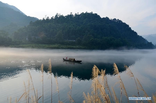 Fisherman fishes on Xiaodongjiang River in C. China's Hunan