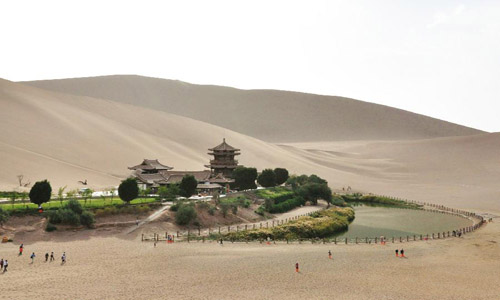 People visit scenic spot of Crescent Lake in Dunhuang, China's Gansu